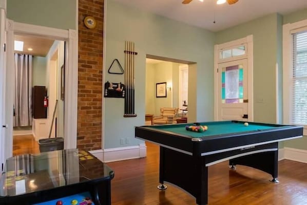 Incredible game room with a pool table, ping pong topper, and arcade machine!