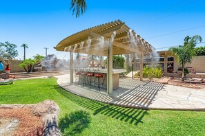 Outdoor eat in kitchen fully surrounded by newly installed misting system