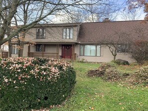 Front of house with guests’ red door entrance. 