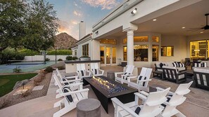 Luxury patio with fire pit, lounge seating, mountain views, and a sport court.