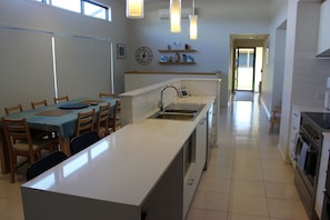 Kitchen, dining, bar and front entrance