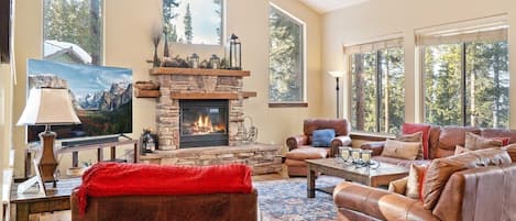 Gather with your group in the stately living room space where you will find plush furnishings, soaring windows, and a striking stone fireplace.