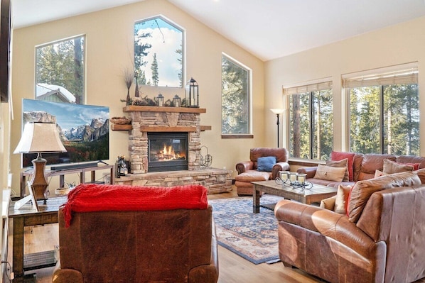 Gather with your group in the stately living room space where you will find plush furnishings, soaring windows, and a striking stone fireplace.