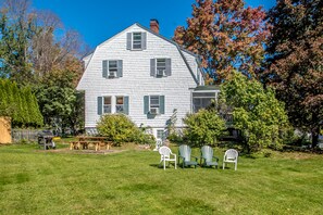 large, private back yard with Weber gas grill, picnic table and Adirondack chair