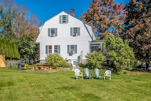 large, private back yard with Weber gas grill, picnic table and Adirondack chair