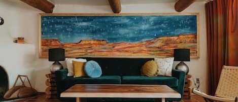 Bedroom with pull out sleeper sofa and custom painting by NM artist Jesse Littlebird