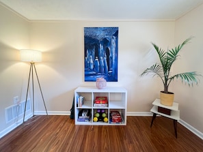 Workout space with yoga mat and weights, games, and a growing library. 