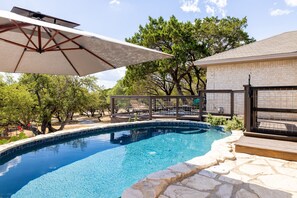 Relax in the pool with a marg and hill country views. 