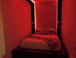 2nd bedroom with a platform bed and mood lighting.