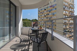 Spacious balcony with outdoor furniture. 