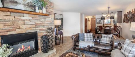 Enjoy the fireplace and mountain views in this cozy living area