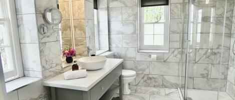 Hazelwood's stunning floor to ceiling tiled bathroom with underfloor heating and a heated towel rail.