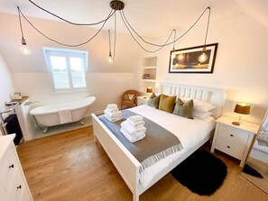 Primary bedroom with roll-top bath