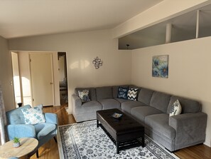 Spacious & bright living room with lots of comfortable places to relax.