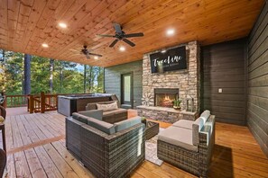 Breathe in the fresh forest air on our tranquil porch, featuring cozy fireplace and plush seating for your al fresco leisure.