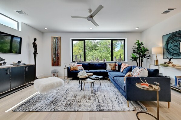 Spacious living room with sectional and smart TV