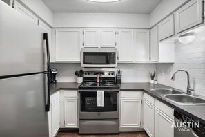 Kitchen with full range, refrigerator/freezer, and dishwasher