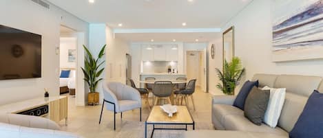 The open-plan living and dining area has been tastefully styled with calm, coastal furnishings. Central cooling and ceiling fans throughout keep temperatures comfortable. 