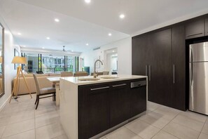 Embrace open-plan living with a well-equipped kitchen, seamlessly integrated with the dining and living area.