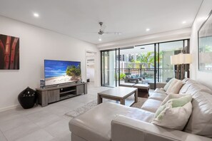 Relax in the comfortable living area, which offers direct access to the balcony. Unwind on the cosy sofa and enjoy the tranquil ambiance of the space.