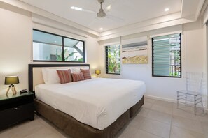 Retreat to the primary bedroom, featuring a comfortable king bed. Rest and rejuvenate in this tranquil haven. And attached ensuite provides privacy to freshen up after a dip in the pool.