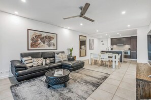 Relax in air-conditioned comfort in the comfortable living area with a leather sofa and a wide-screen TV for everyone to enjoy.
