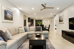 A large L-shaped sofa invites you to cosy up with a movie after a day at the beach.