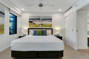 Unwind in the spacious primary bedroom featuring a king-sized bed and an ensuite for added convenience.