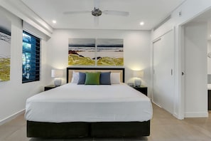 Unwind in the spacious primary bedroom featuring a king-sized bed and an ensuite for added convenience.