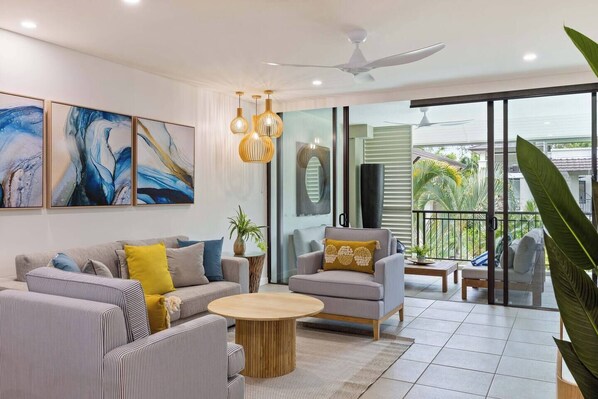 Relax in a spacious living room equipped with both air-conditioning and a ceiling fan for utmost comfort. The sofa bed can be set up to sleep two children or one adult.