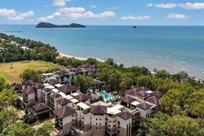 Set against a backdrop of lush greenery, this beachfront resort features an expansive pool area and offers the ultimate escape—just steps away from the shoreline.