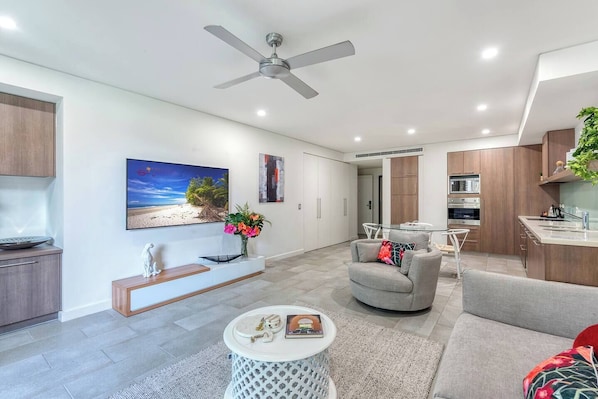 A comfortable lounge and swivel chair invite you to kick back while watching the smart TV.