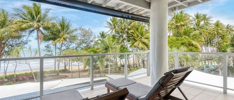 Step out onto the balcony and enjoy your morning coffee while overlooking the palm-fringed beach.