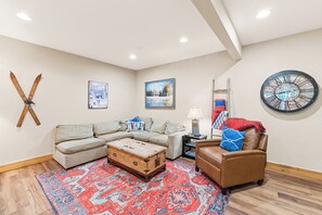 Spacious first floor living room with flat screen TV and ample seating.
