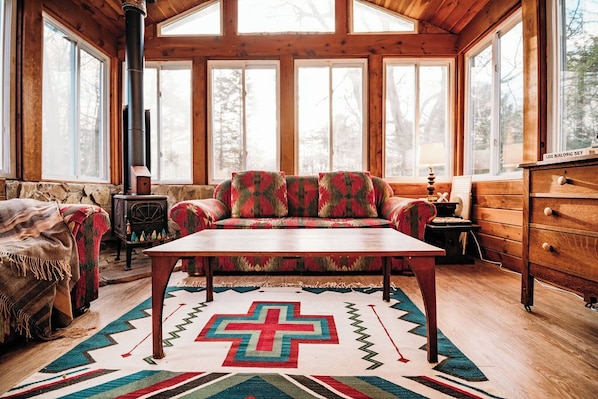 Our four seasons porch sits just off of the kitchen and has a working, wood burning stove. It's a great place to hang out!