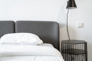 Chic simplicity meets comfort in this peaceful bedroom oasis—perfect for relaxation.