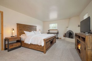 Master Bedroom suite, furnished with decorative kiva fireplace, king size bed.