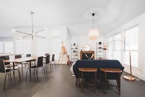 Open floorplan with modern light fixtures and sophisticated furniture pieces