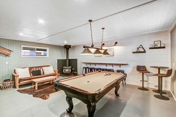 Detached Gameroom with stove, 7 ft. pool table, smart TV & shuffleboard.