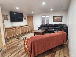 living room with large TV and daybed