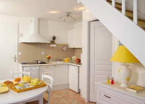 Prepare meals in the kitchenette and enjoy them at the dining table.