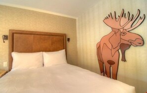 There is a luxurious king-sized bed in this bright and open room.