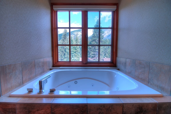 Enjoy soaking in the beautiful jacuzzi tub right in your room! Views vary.