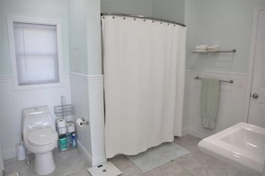 Master bathroom tub/shower en-suite (level 1) - Guest House Maine