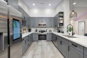 Custom Designed Kitchen with New Samsung Steel Appliances and a New Family Hub Touch Screen Samsung Fridge. 