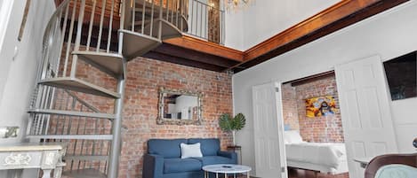 Living room space with staircase leading to one of the bedrooms 