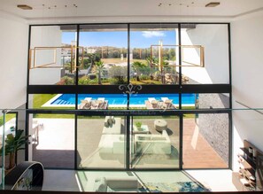 Impressive living area with double height bay window includes dining area