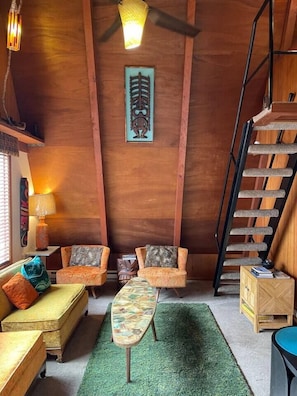 Cozy A-Frame- Living Area with ceiling open to second story loft.