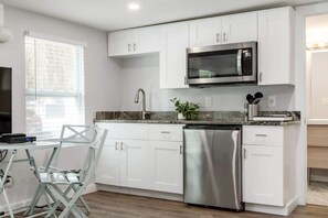 Kitchenette with a burner, mini-fridge and a microwave