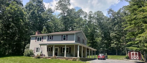 Front view w/ Porch, Parking, & Bike Shed